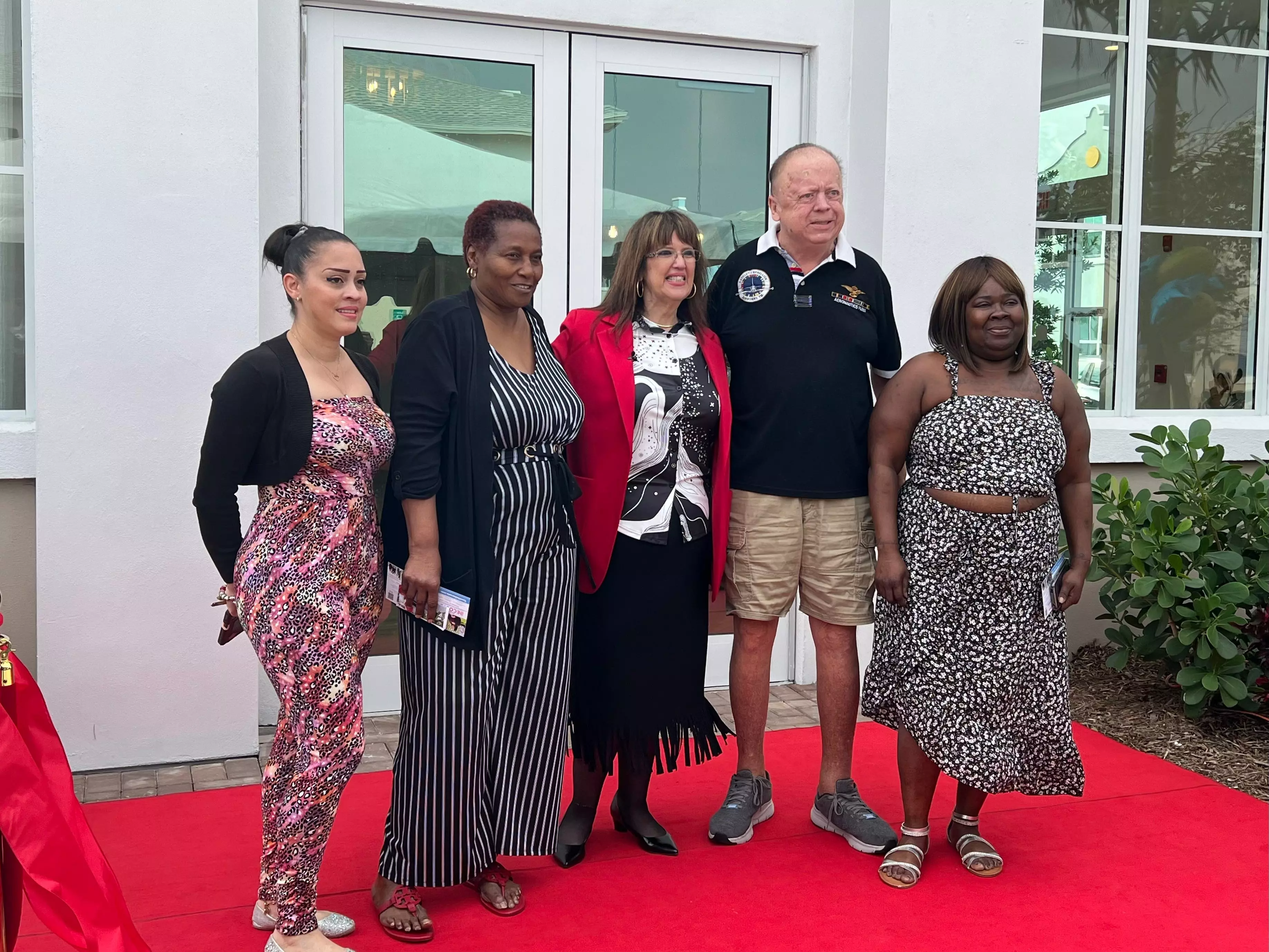 President of the Delray Beach Housing Authority Shirley Erazo stands with new residents of Island Cove Apartments at 900 S.W. 12th Ave. in Delray Beach.