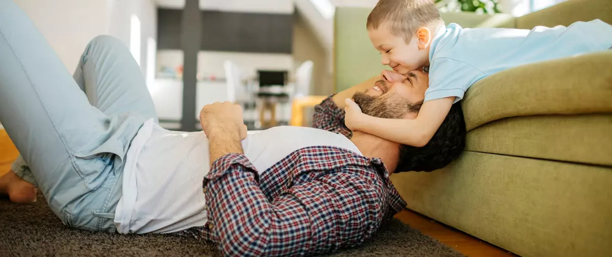 A father and son playing now that their air conditioner repair is complete