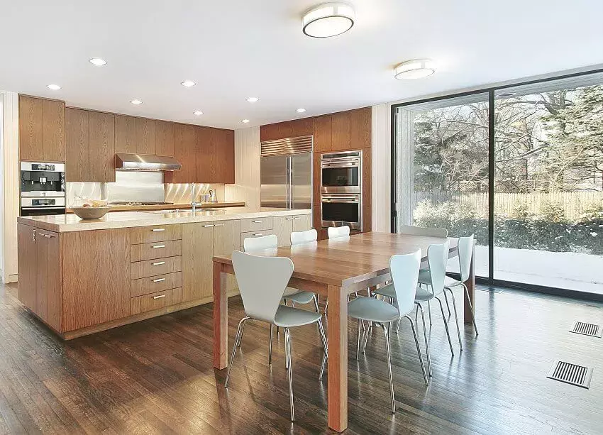 Elegant kitchen with crystal chandelier, waterfall marble, island, and laminate cabinets