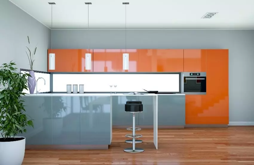 Kitchen with natural tones with rustic modern island, brick backsplash, and laminate cabinets