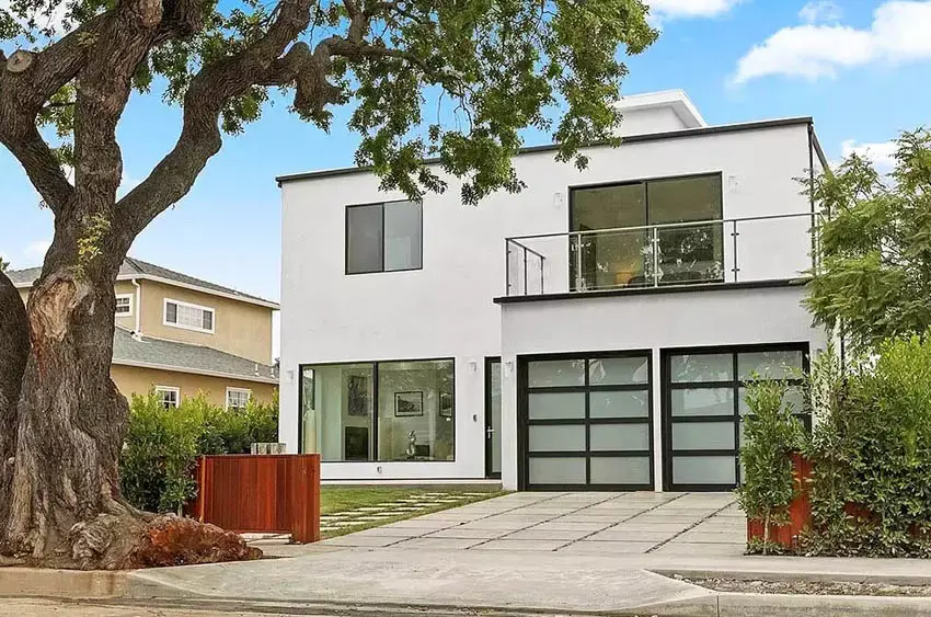 Home with balcony, picture windows, and glass panel doors