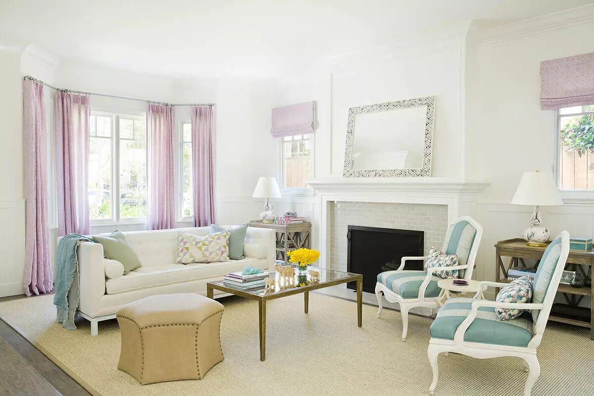 transitional white formal living room with traditional seating and geometric patterned scatter cushions