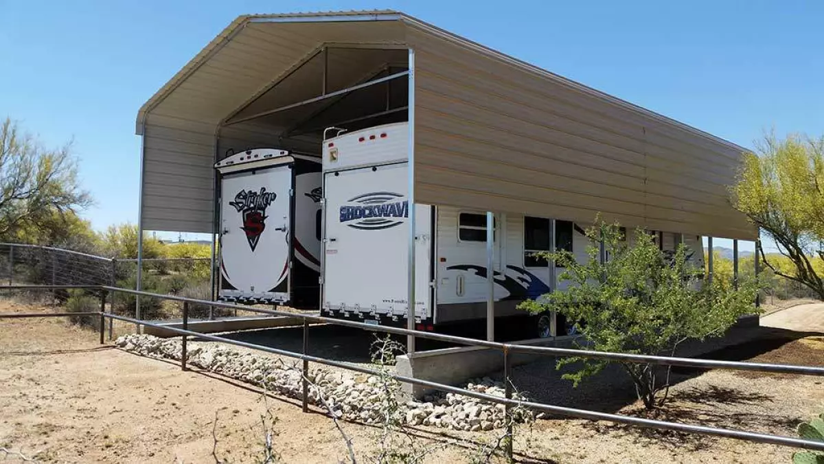 Two RVs parked under a carport in a rural setting - DIY RV carport