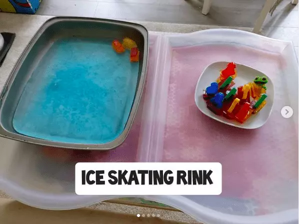 Blocks of colored ice in a water table