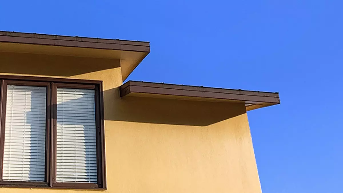 Section of home showing roof and upstairs windows