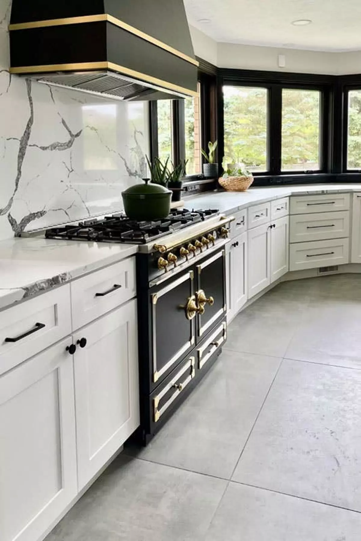 White cabinets with black accent, and granite countertop