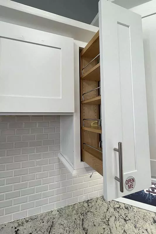 White kitchen cabinets with silver pulls with subway white tiles, Marble Countertops