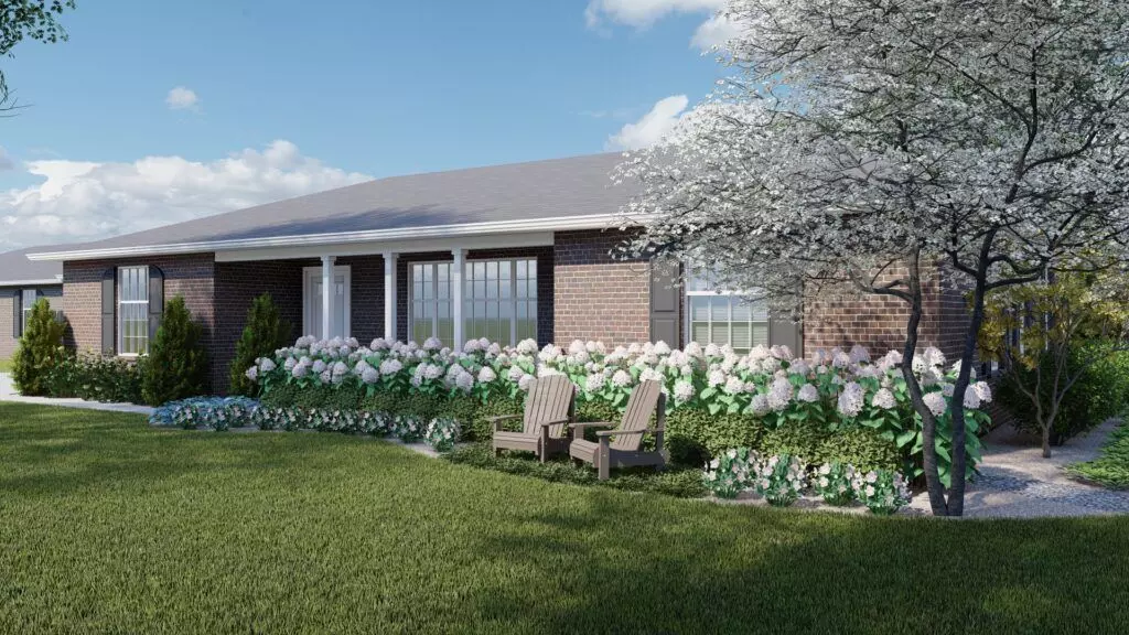 The Adirondack chairs and boxwood in front of the house create a moment and focal point for this simple front yard design