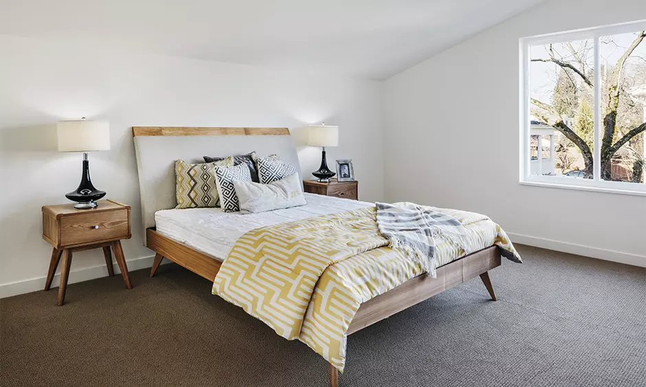 A mid-century modern bedroom set with a jaali headboard comes with a cream color scheme