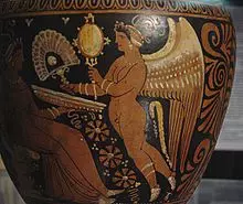 Eros offering a fan and a mirror to a lady. Ancient Greek amphora from Apulia, Archaeological Museum in Milan, Italy