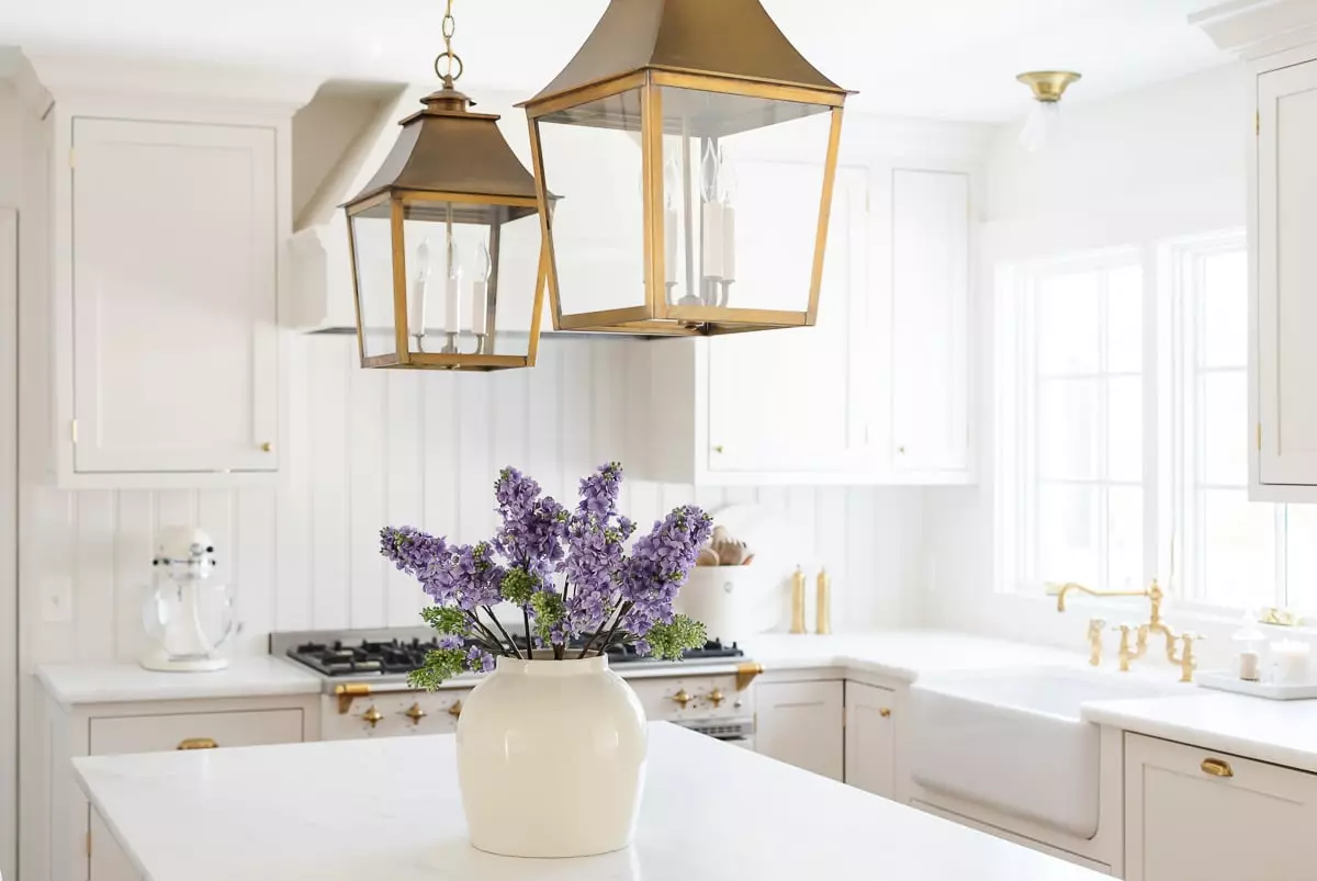 A cream kitchen with inset cabinets and a wood island.