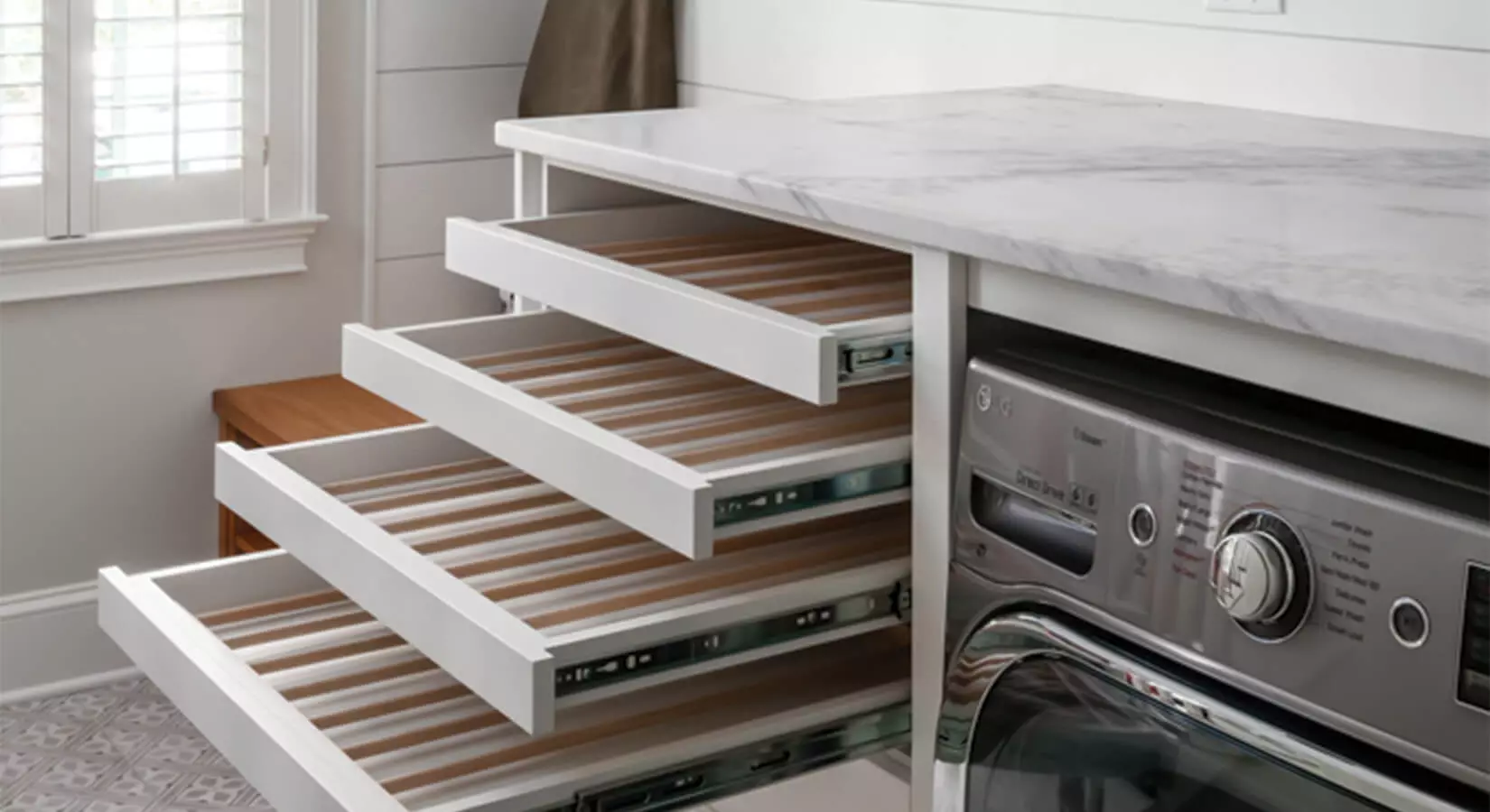 White washer and dryer with custom pull-out cabinet in between.