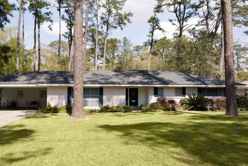 A stunning light yellow painted wooden sidings ranch house with wooden shingle roofing