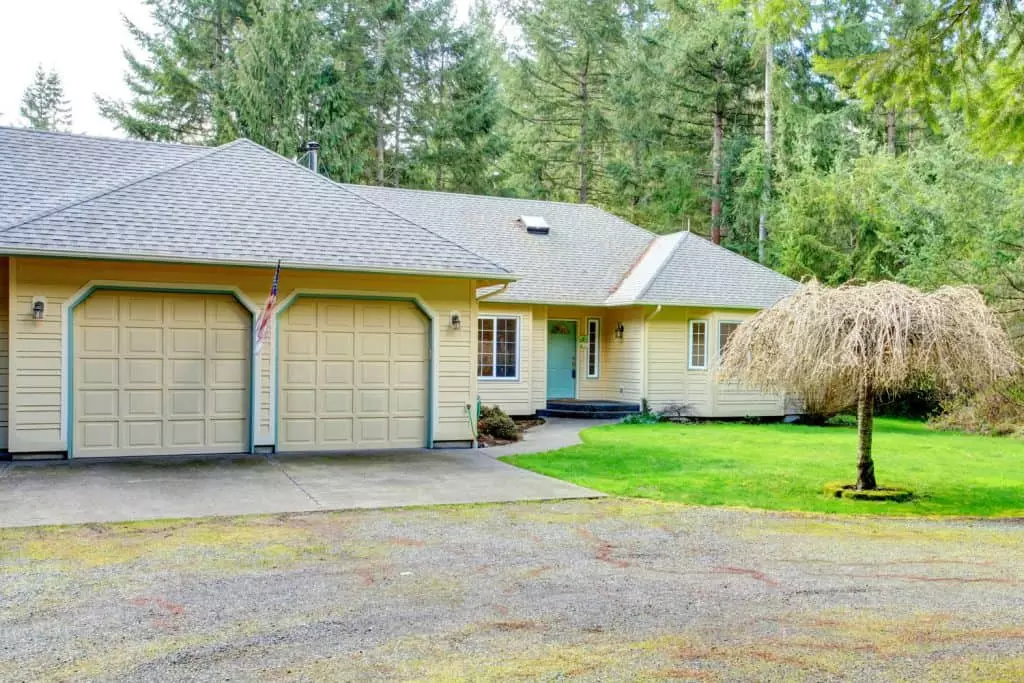 A huge and stunning beige painted wooden sidings and asphalt shingle roofing