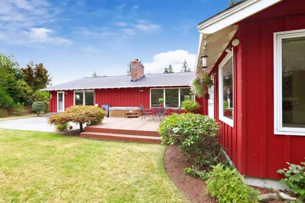 Light green painted wooden sidings ranch-style house with breathtaking landscaping