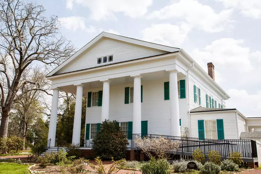 White Colonial House with Shiplap Walls