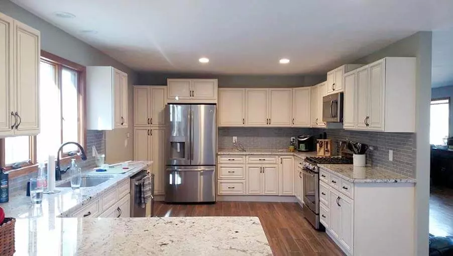 L-shaped kitchen with dark brown wood cabinets and granite countertops.