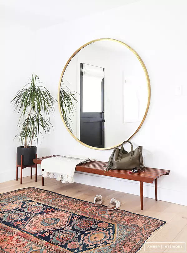 Large round mirror in modern hallway