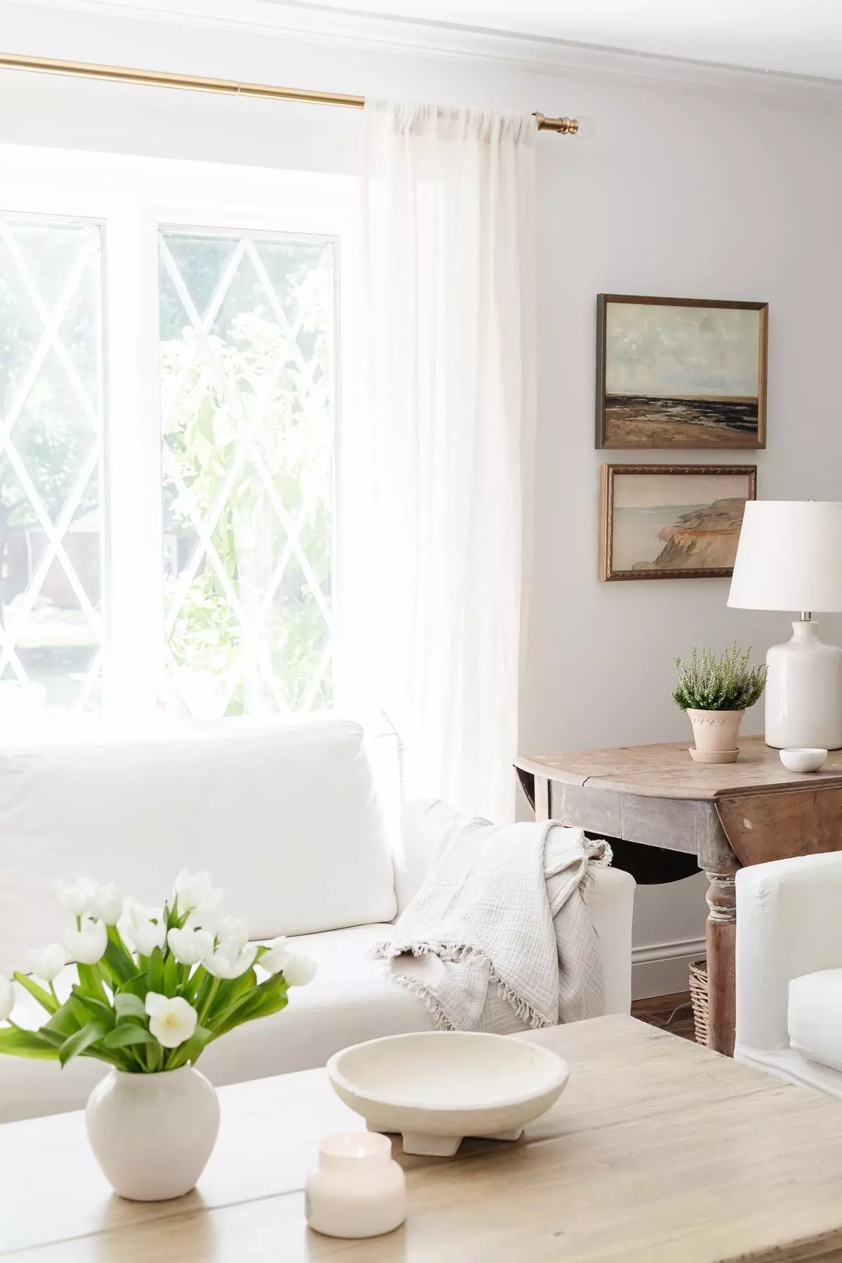 White sofa in a white living room with a wood coffee table