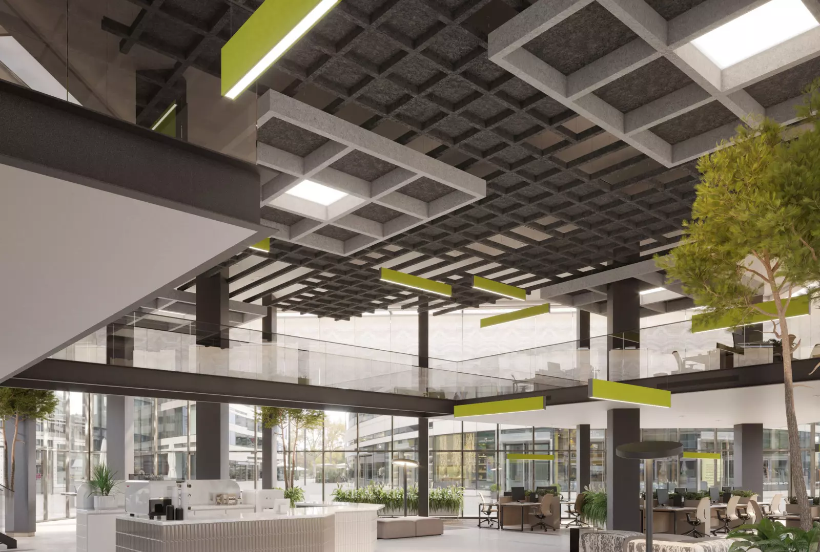 Open office space with ample seating areas. There is a tree inside the space. There are green, gray, and white ceiling panels.