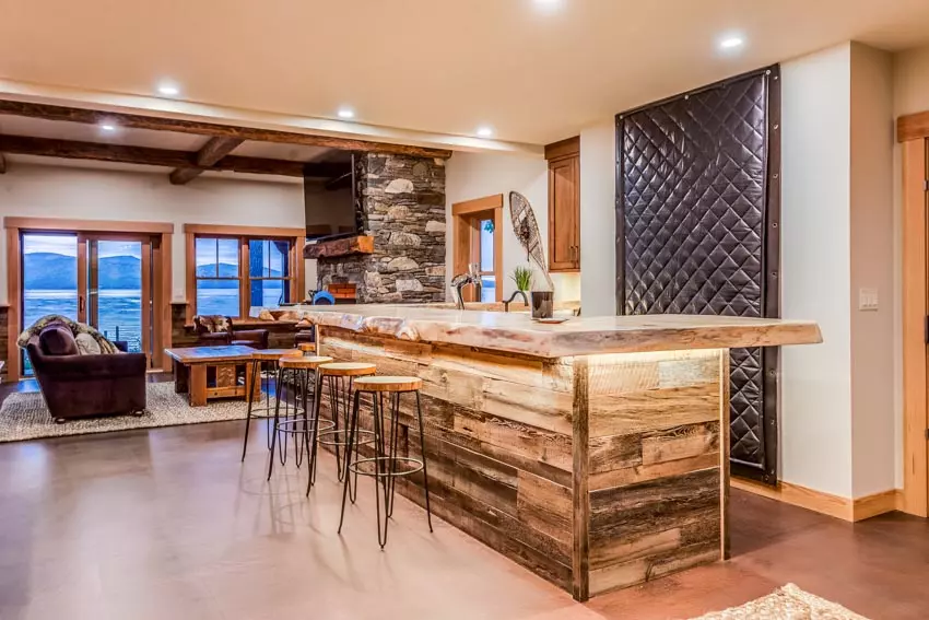 Living room with illuminated wooden bar counter and stools