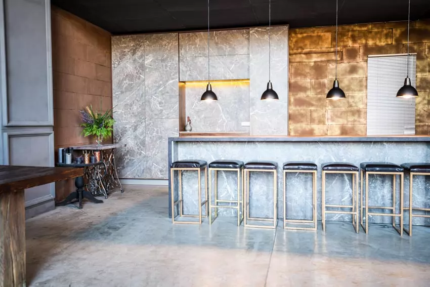 Room with coffered ceiling, recessed lighting and black marble bar