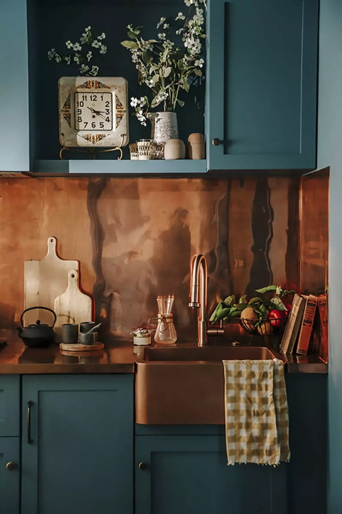 Deep green kitchen with copper faucet