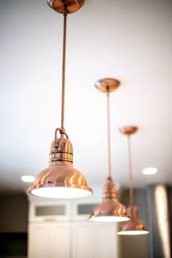 Copper pendant lights hanging in kitchen