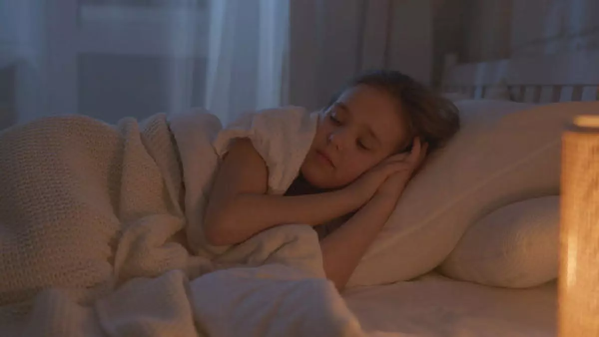 Girl sleeping on white bedding