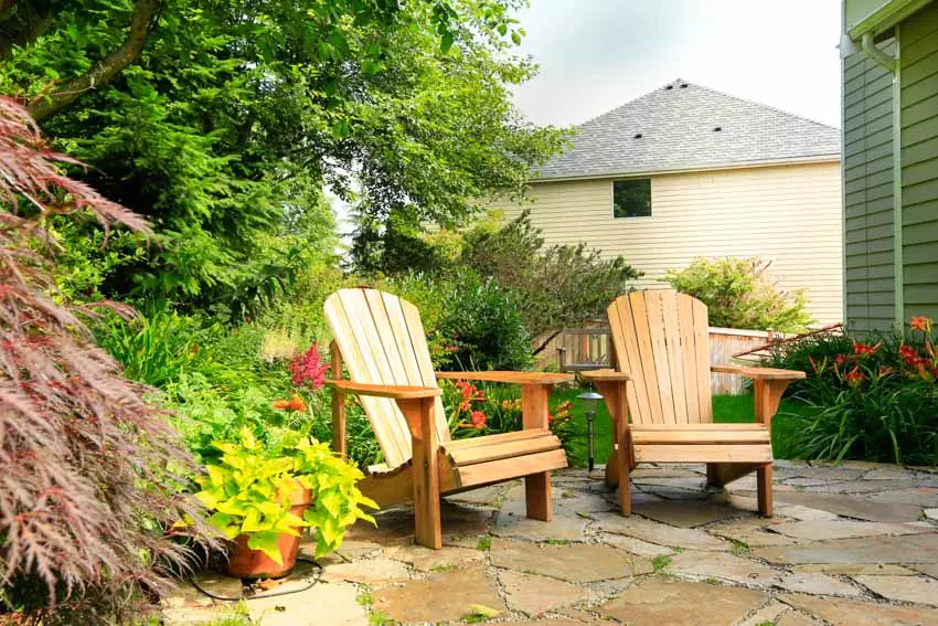 Backyard area with three gray Muskoka chairs