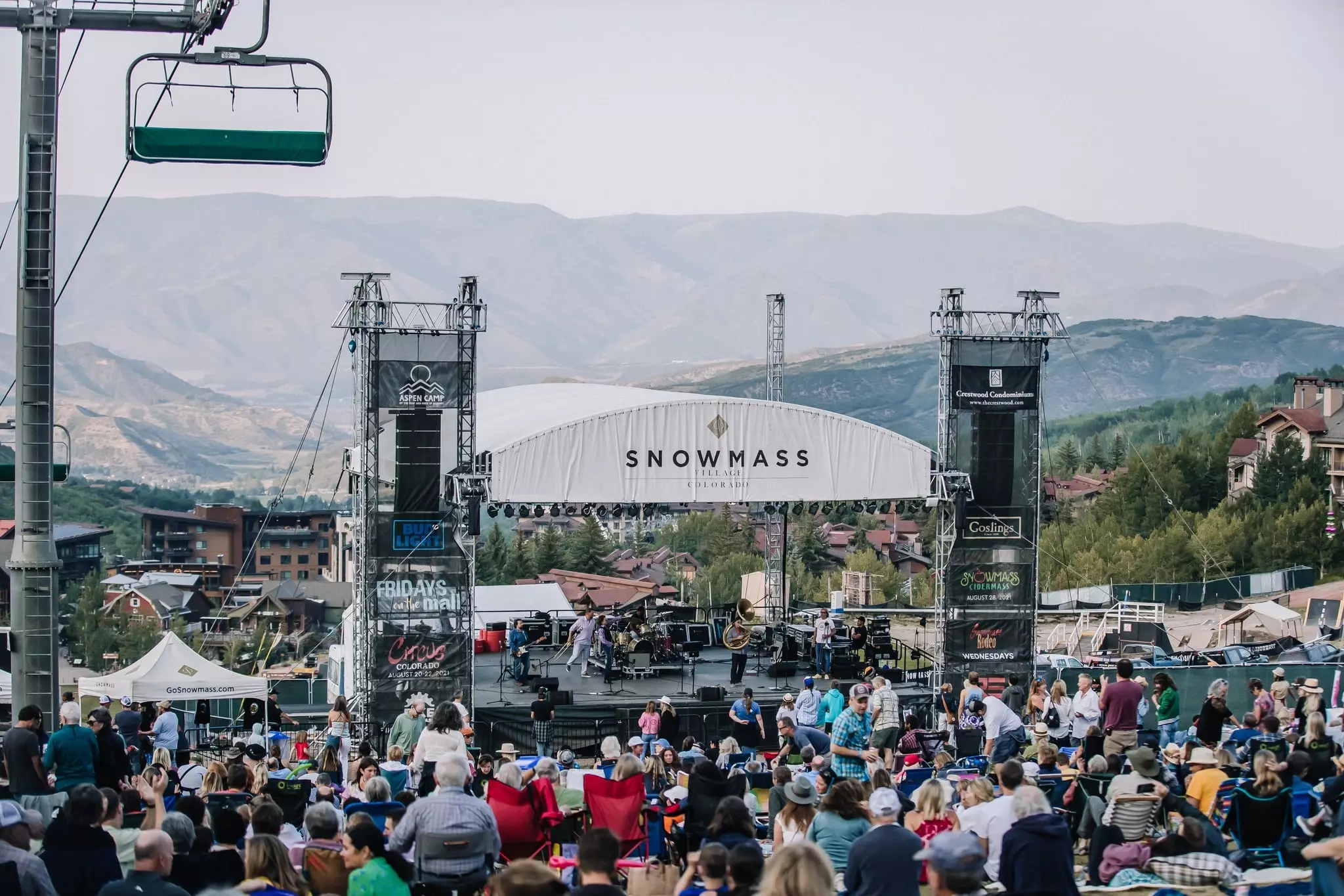 Group of people in front of stage listening to live music outdoors