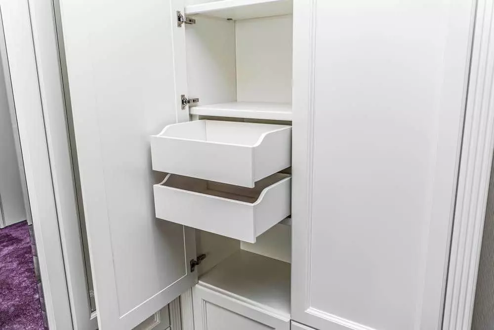 White armoire with open door and pulled-out drawer