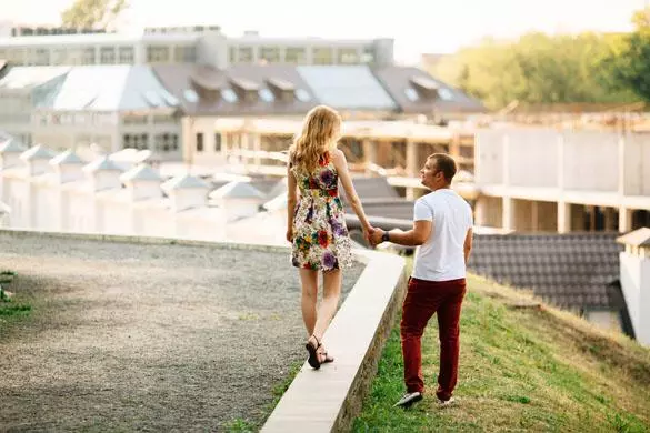 Attractive young couple lovely walking in the city and looking at each other