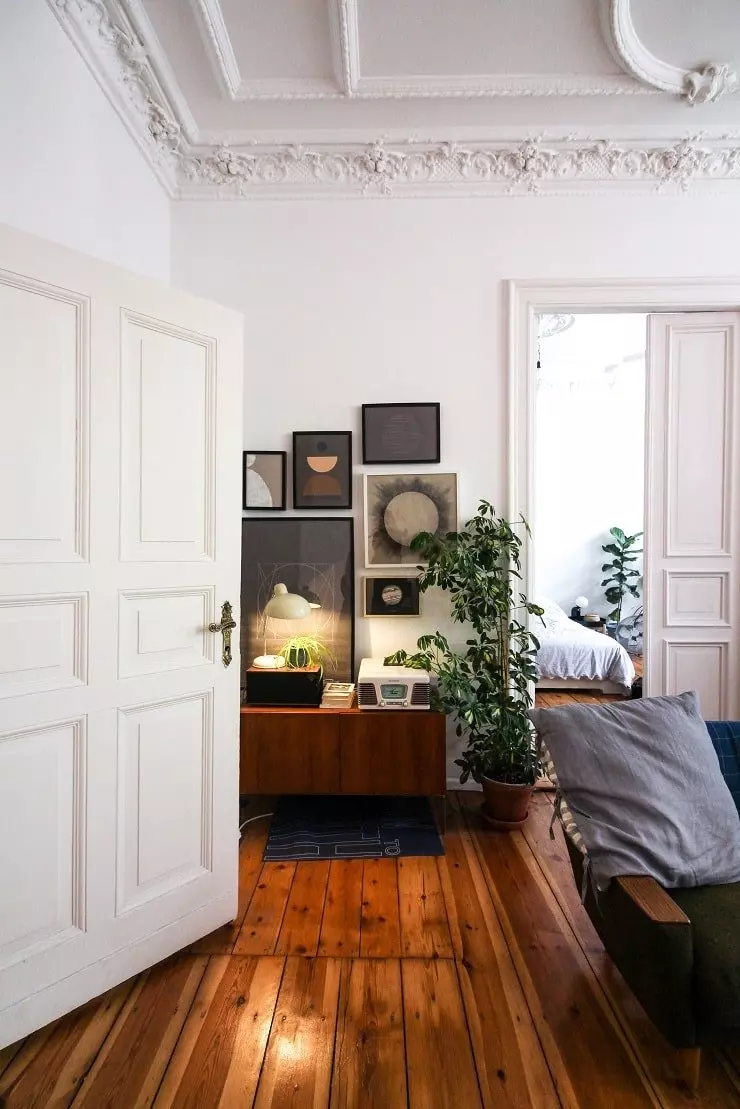 Ornate White Room with Dark Wood Floors and Furniture