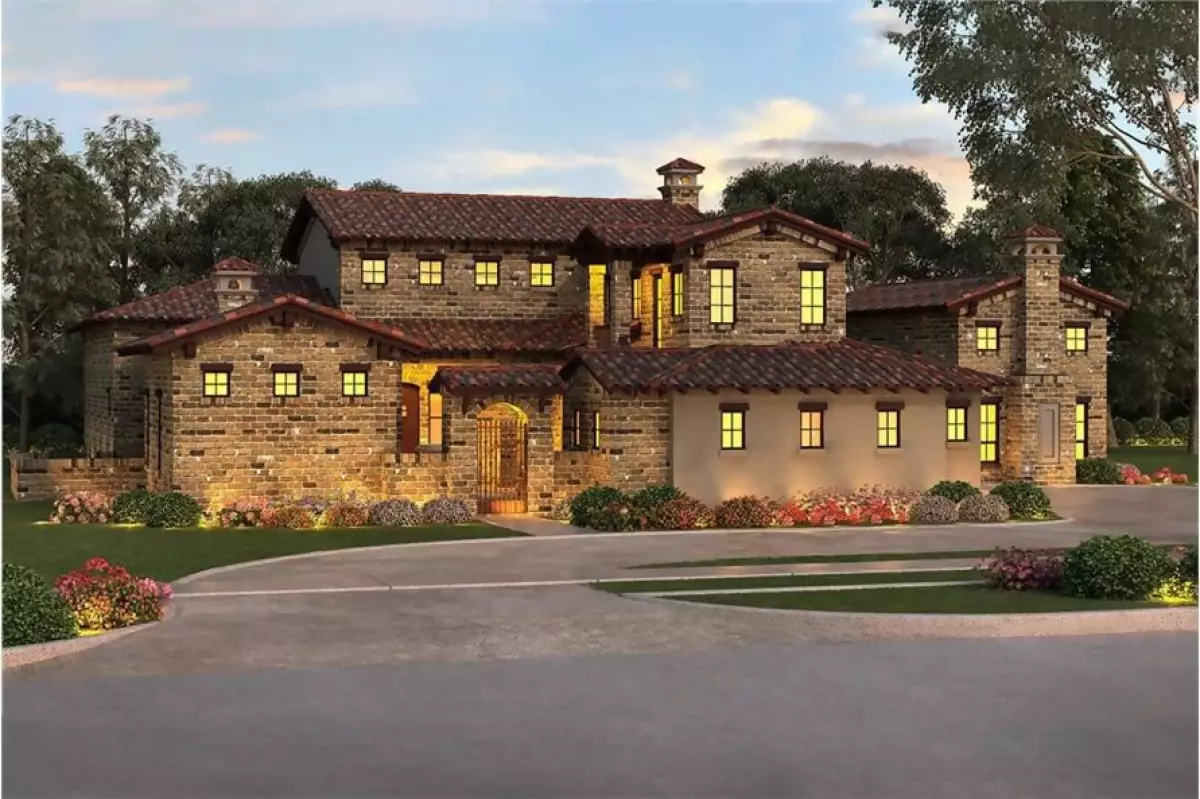 Southwest style home with brown tile roof and stone exterior