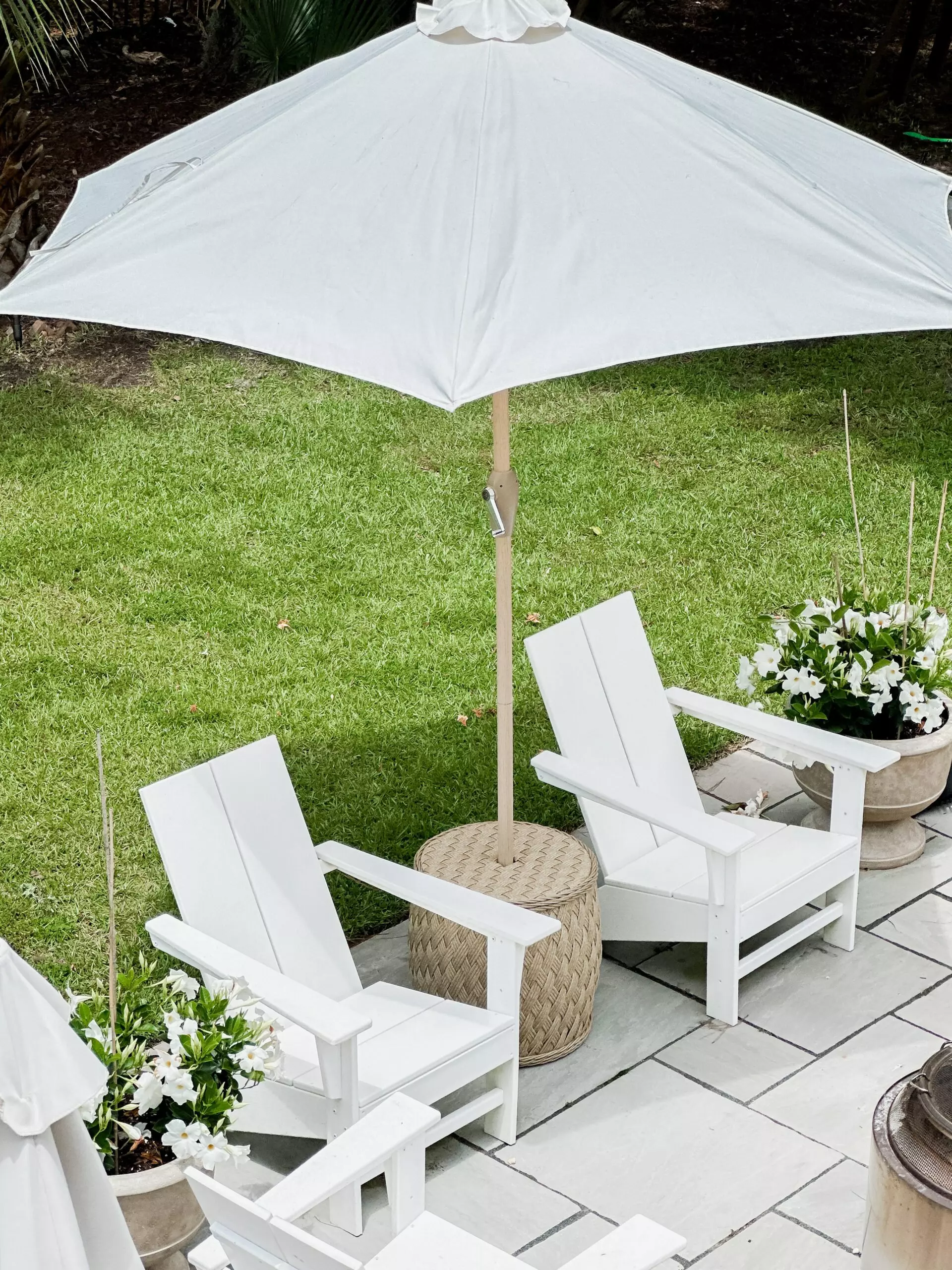 Outdoor umbrella stand table that looks like rattan.