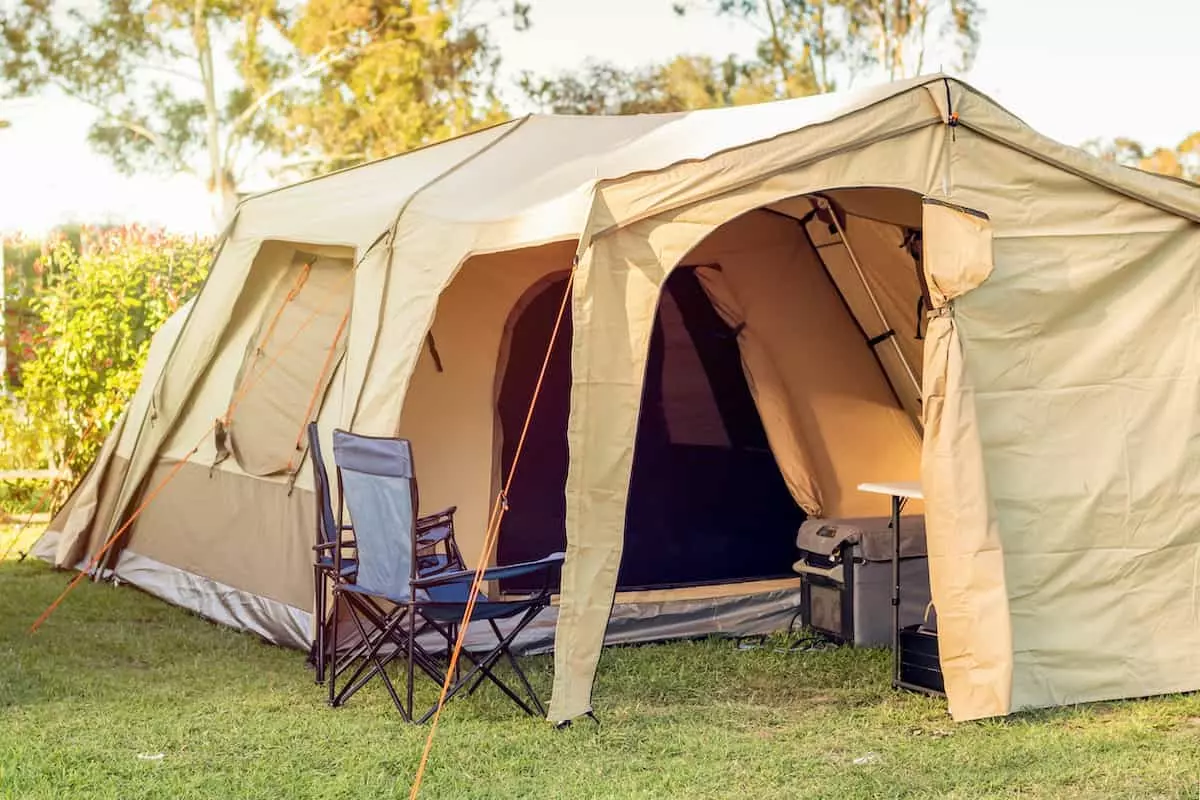 A large camping tent campsite with a generator.