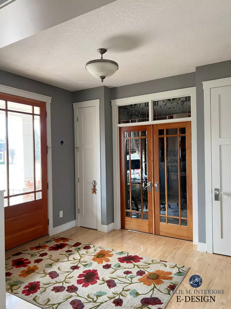 Dark wood trim, stairs and doors in older home entryway