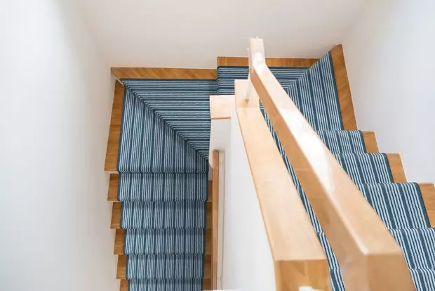 wooden stairs with a colorful blue stair runner