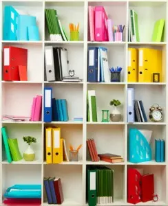 White office shelves with different stationery, close up