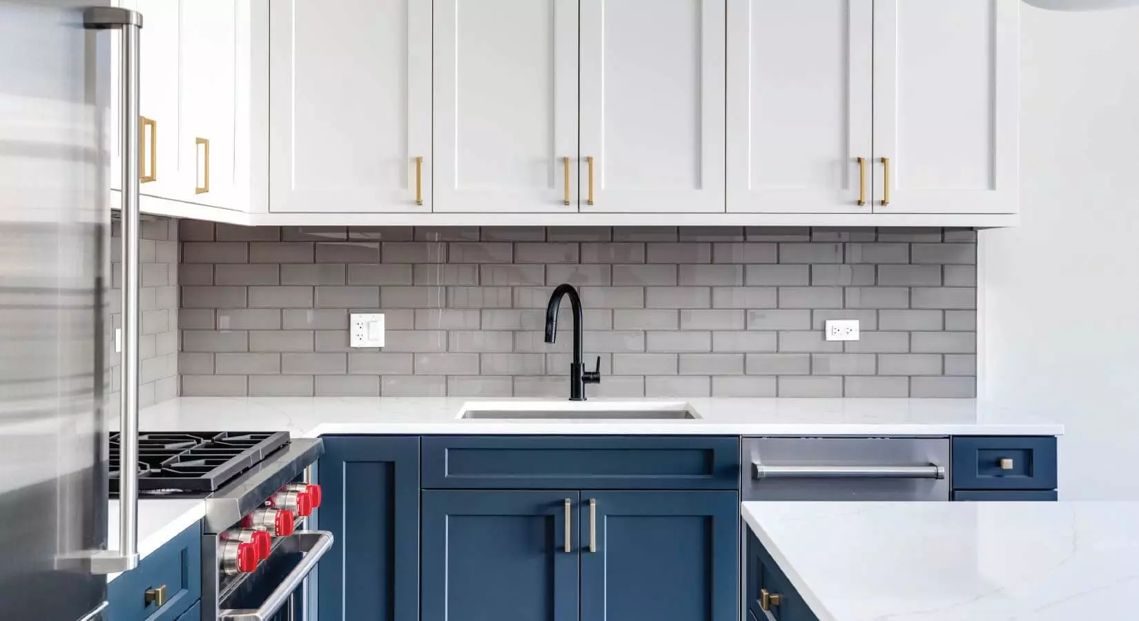 Kitchen with dark blue cabinets, gray tile backsplash, and gray barstools.