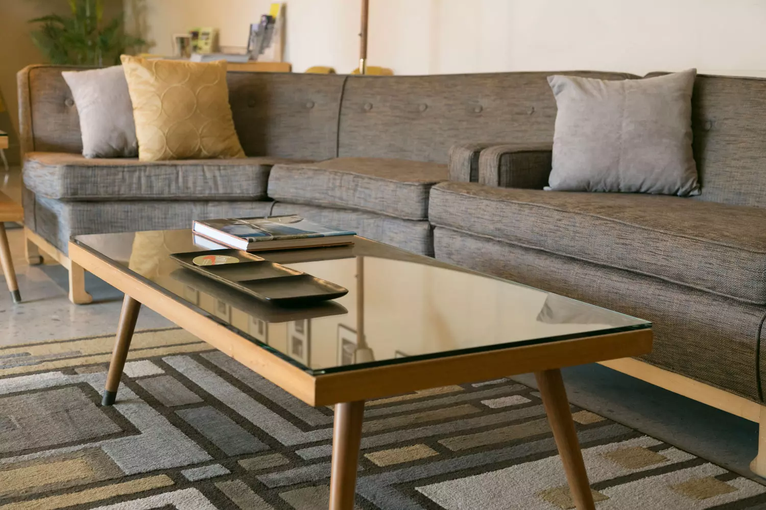 A table and sofa in a living room.