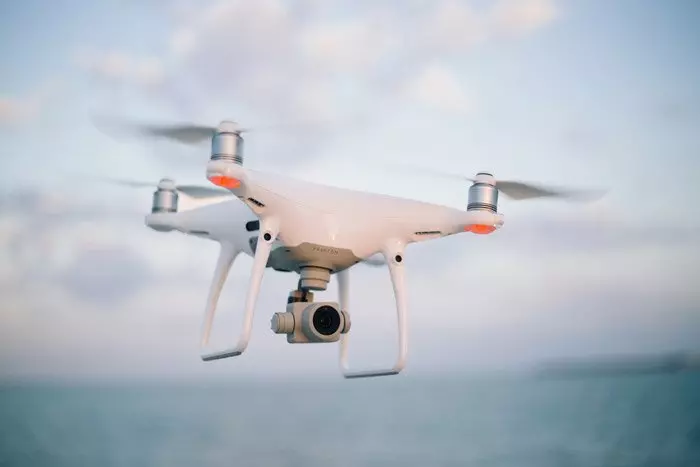 Photo of a man holding a drone