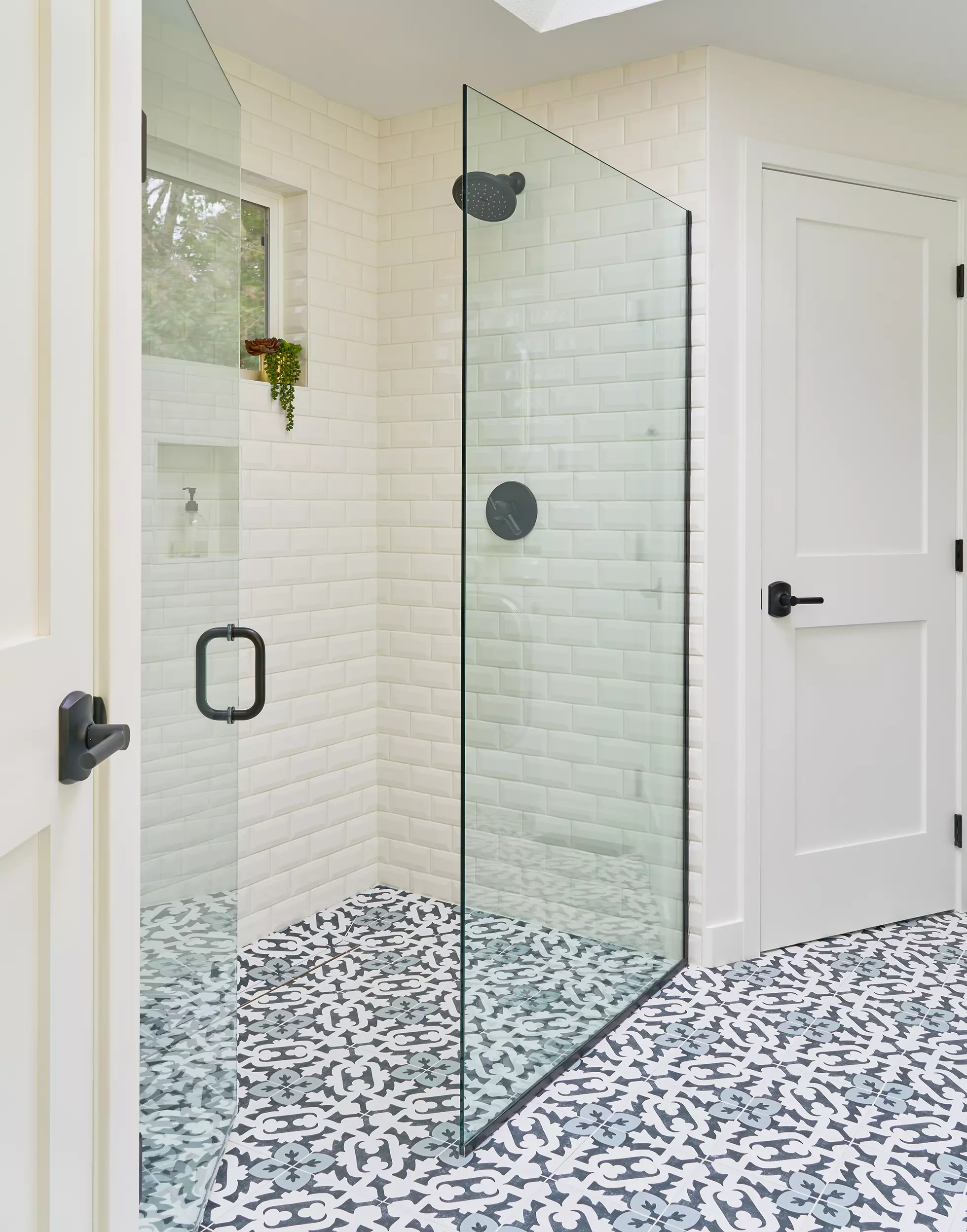 Tile bathroom with curb-less shower and lever door handles