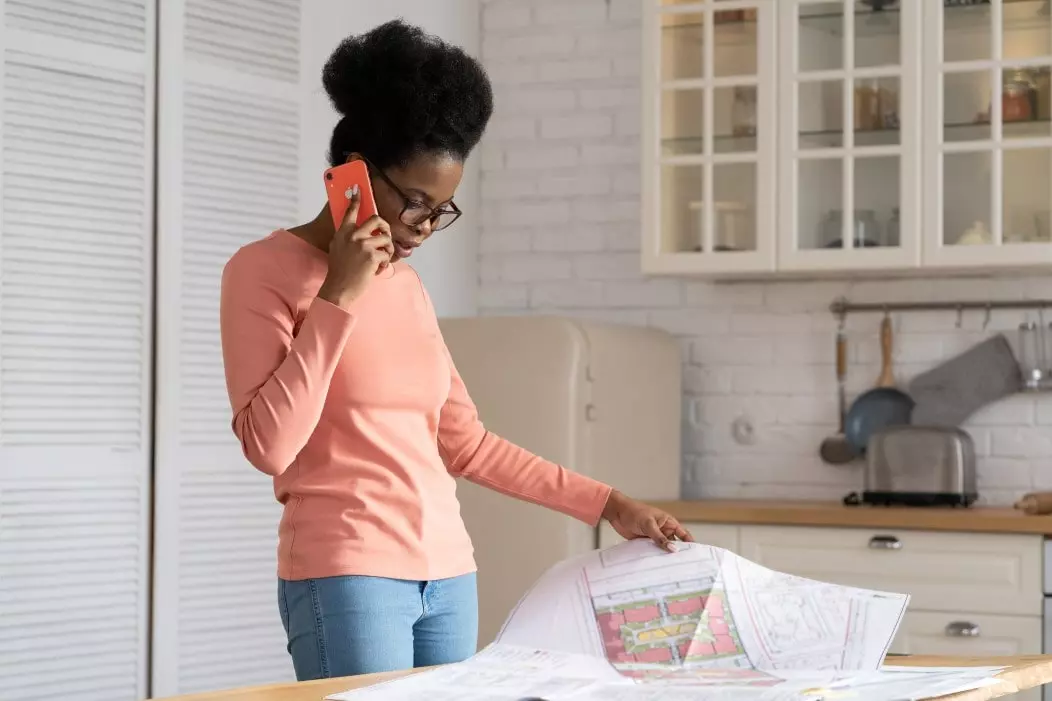 woman looking at house plans