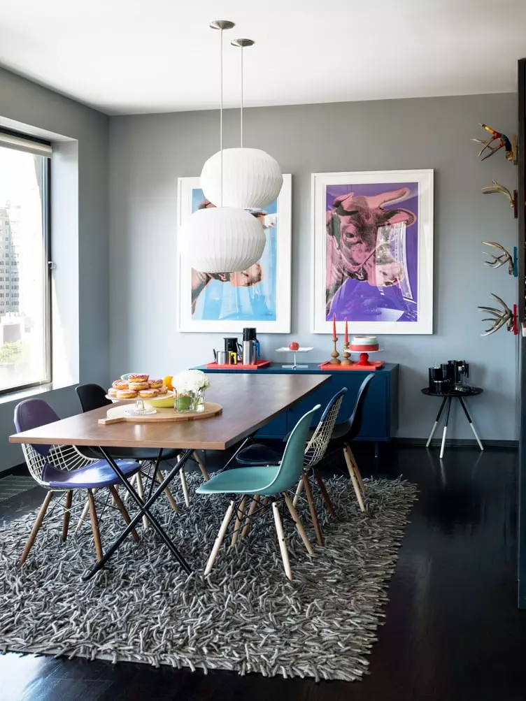 Mid-Century Modern Black Shell Eames Chairs in Rustic Dining Room with Cowhide Rug