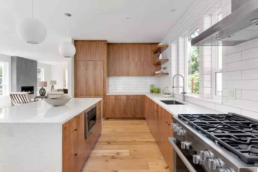 Kitchen with extended floating wood cabinets, oven, and countertops