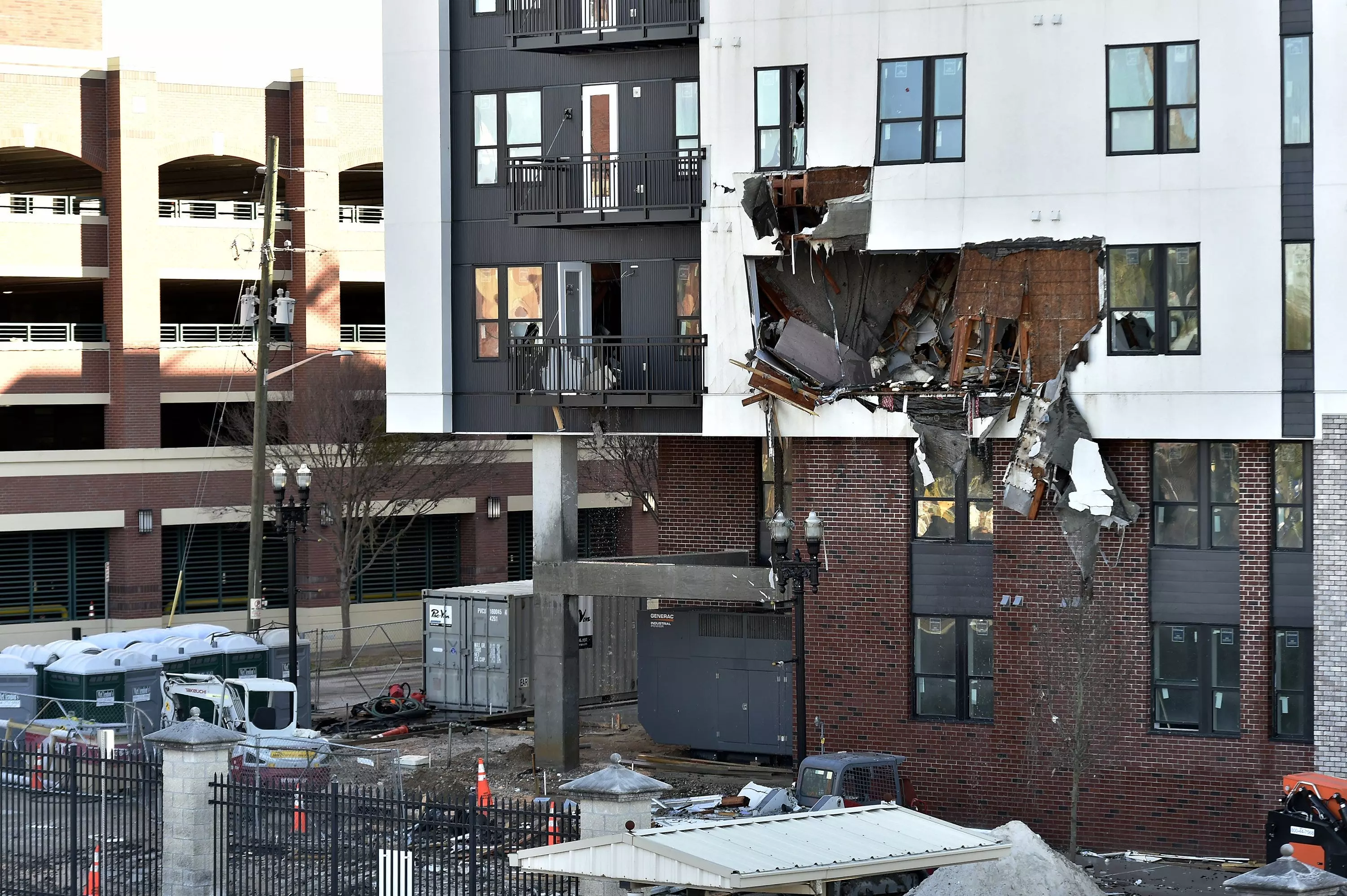 Sections of the west side of the RISE Doro apartment building show extreme damage Monday morning. Crews worked through the night to contain the fire that burned through the apartment building under construction on A. Philip Randolph Blvd. near the baseball stadium and the Veterans Memorial Arena.