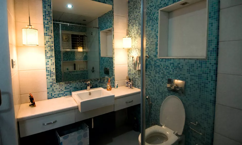 Simple small bathroom ideas for India with a classic penny-tiled triangle corner add a touch of vintage charm