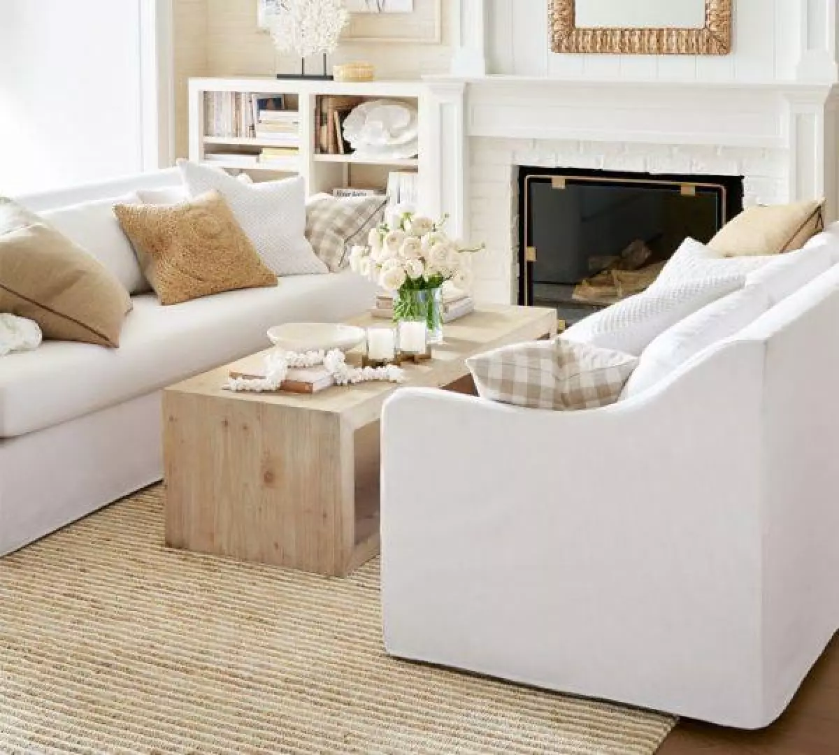 Beautiful white slipcovered sofa with sloped arms and light wood coffee table